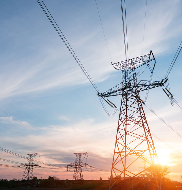 Energy line up against a blue and orange sky