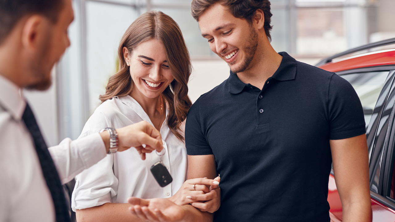 Young couple buying a new car.